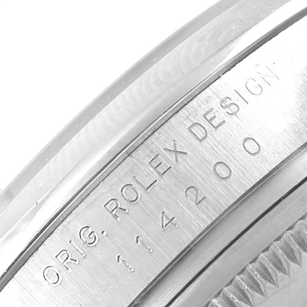 The image shows a close-up of the engraved side of the bezel for the Rolex Air-King 114200 Men's Stainless Steel White Dial 114200 Men's Stainless Steel White Dial watch.