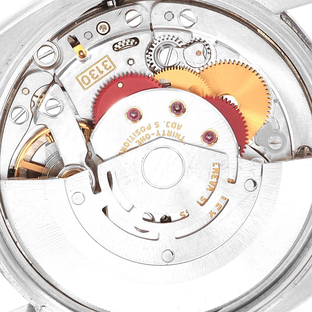 Close-up of the movement mechanism from a Rolex Air-King 114210 Men's Stainless Steel Silver Dial 114210 Men's Stainless Steel Silver Dial watch, highlighting gears and internal components.