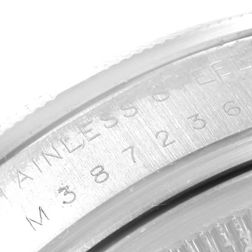 This is a close-up of the case back engraving on a Rolex Air-King 114210 Men's Stainless Steel Silver Dial 114210 Men's Stainless Steel Silver Dial watch, highlighting its model details and serial number.