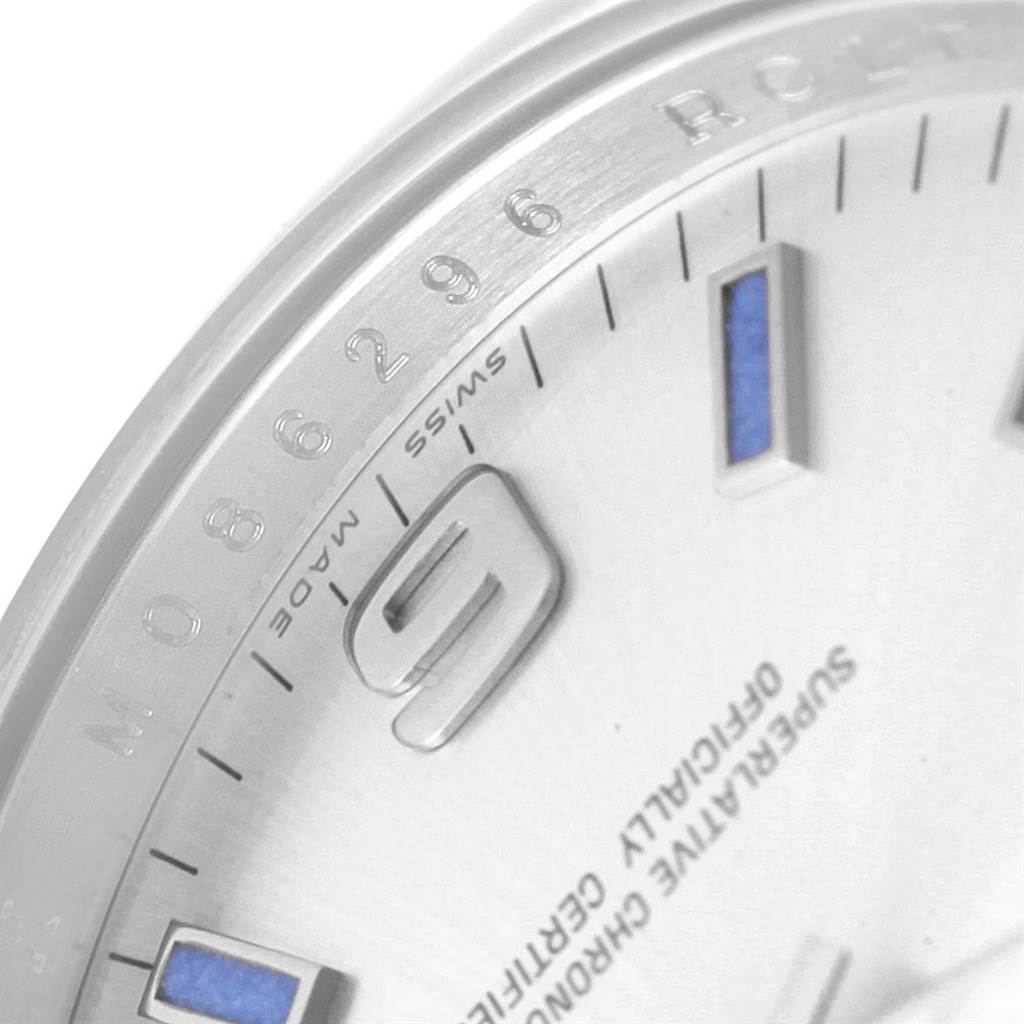 This close-up image of a Rolex Air-King 114200 Men's Stainless Steel Silver Dial 114200 Men's Stainless Steel Silver Dial watch shows the dial, numerals, and part of the bezel from a lateral angle.