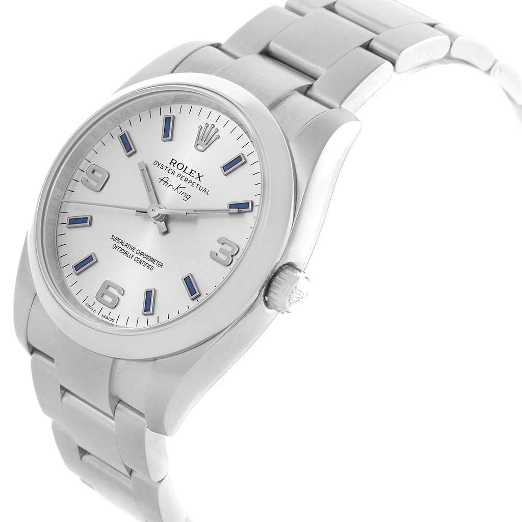 The Rolex Air-King 114200 Men's Stainless Steel Silver Dial 114200 Men's Stainless Steel Silver Dial watch is shown at an angle highlighting the face, crown, and part of the bracelet.