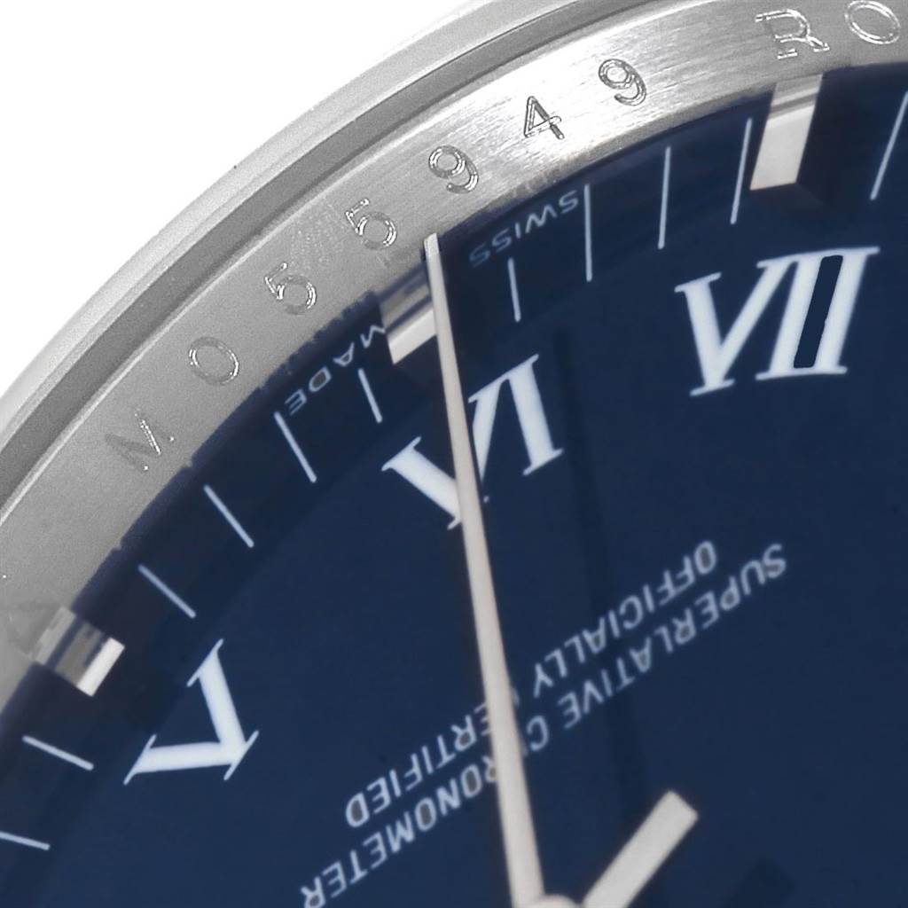The close-up image shows the bezel, part of the dial with Roman numerals, and the second hand of a Rolex Air-King 114200 Men's Stainless Steel Blue Dial 114200 Men's Stainless Steel Blue Dial watch.