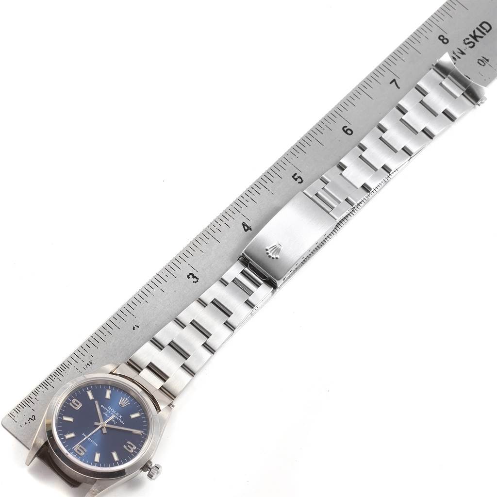 The image displays a Rolex Air-King 14000 Men's Stainless Steel Blue Dial 14000 Men's Stainless Steel Blue Dial watch laid next to a ruler, showing the face and bracelet.