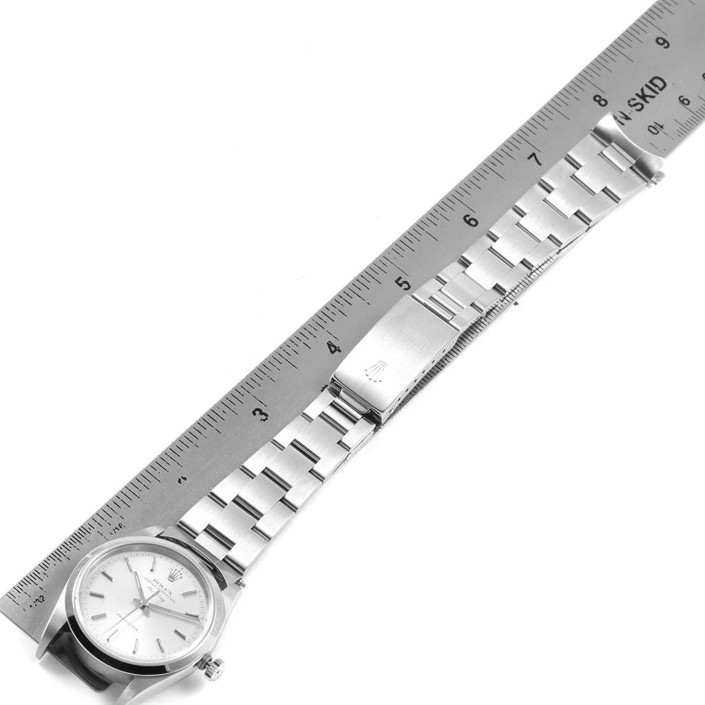 The image shows a top-down view of a Rolex Air-King 14000 Men's Stainless Steel Silver Dial 14000 Men's Stainless Steel Silver Dial watch, including its face, bracelet, and clasp, alongside a ruler for scale.