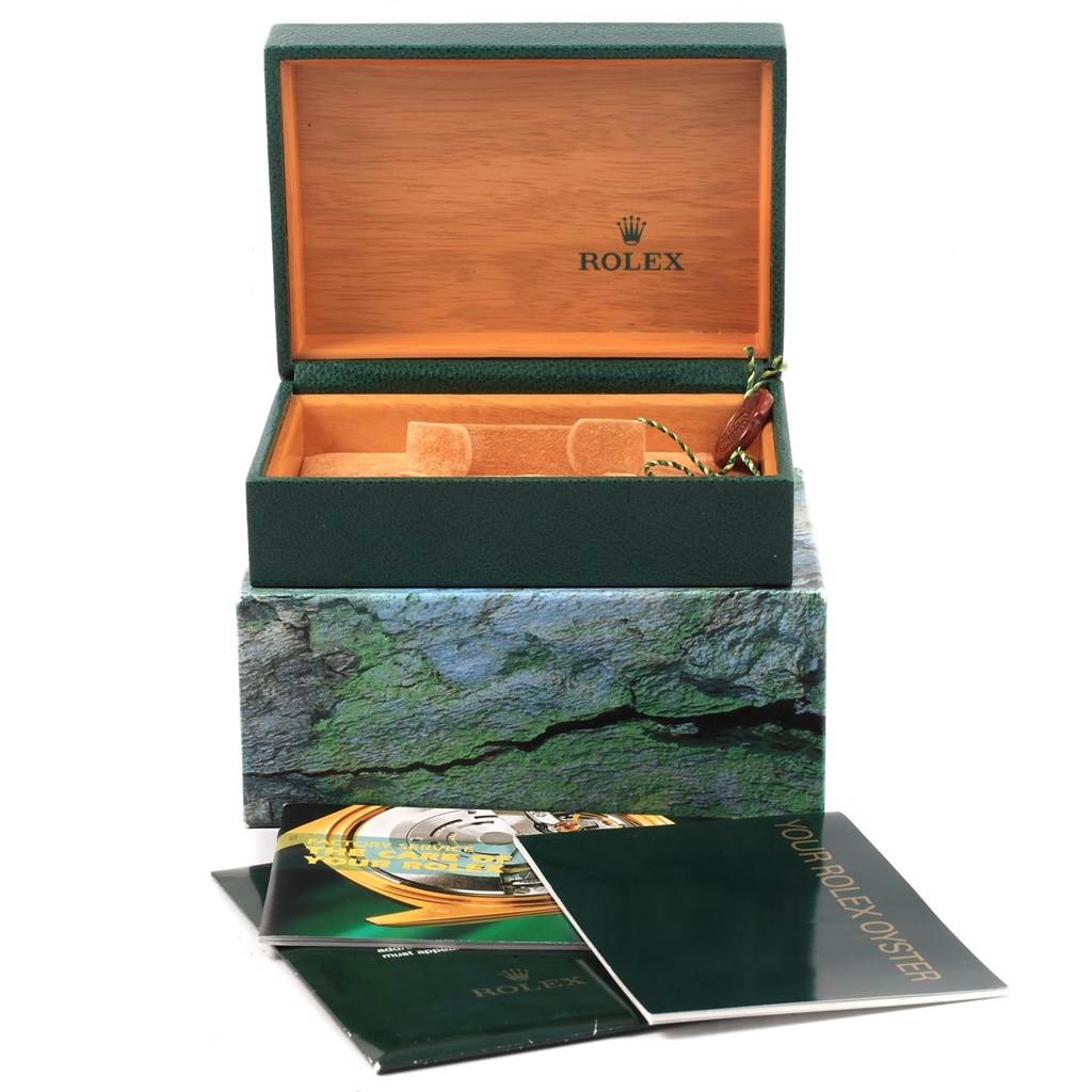 This image displays an open green Rolex Air-King 14000 Men's Stainless Steel Silver Dial 14000 Men's Stainless Steel Silver Dial watch box with its interior and accompanying booklets visible.