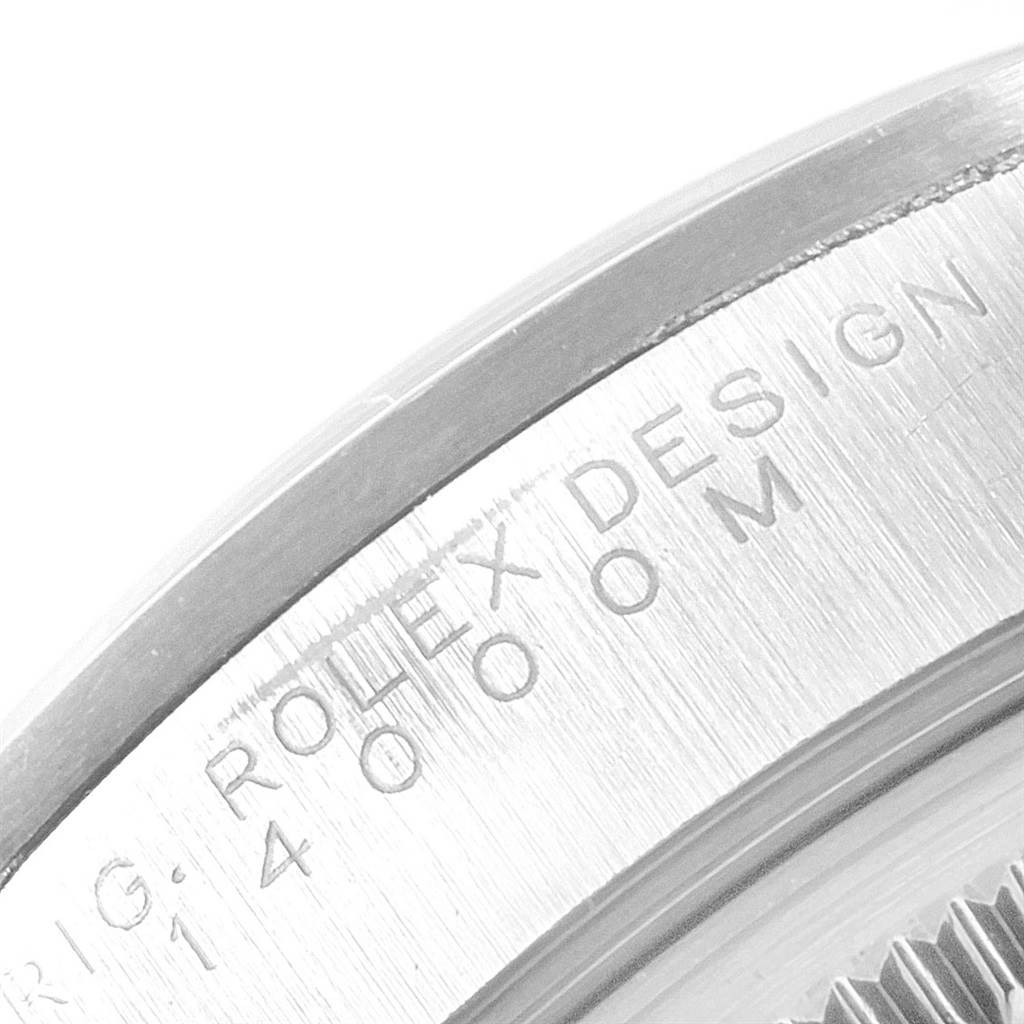 This close-up image shows the engraved side of the bezel of the Rolex Air-King 14000 Men's Stainless Steel Silver Dial 14000 Men's Stainless Steel Silver Dial watch model.