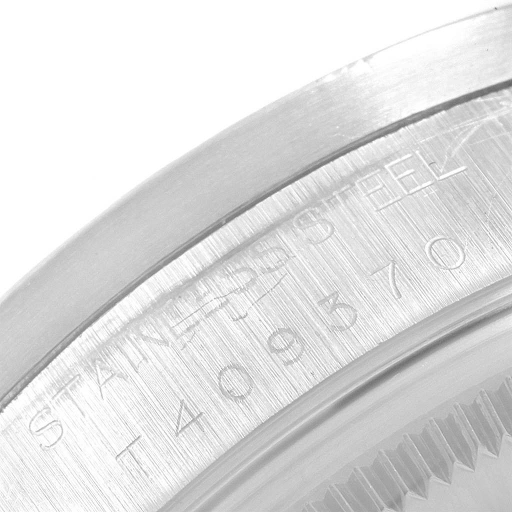 The image shows a close-up of the stainless steel bezel and etched detailing of a Rolex Air-King 14010 Men's Stainless Steel Silver Dial 14010 Men's Stainless Steel Silver Dial watch.