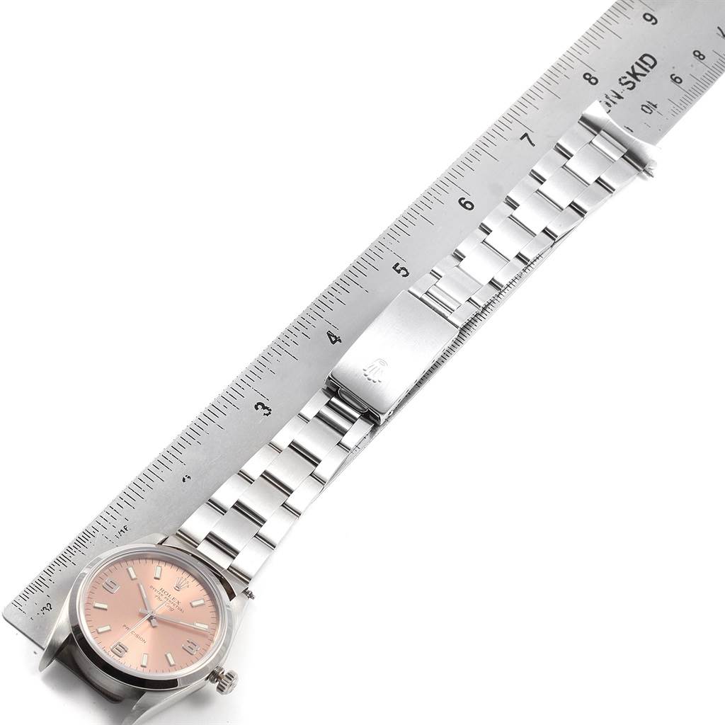 The Rolex Air-King 14000 Men's Stainless Steel Pink Dial 14000 Men's Stainless Steel Pink Dial watch is shown with its dial and bracelet fully visible, horizontally aligned with a ruler.