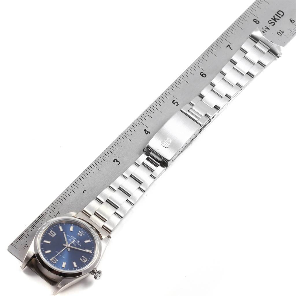 The Rolex Air-King 14000 Men's Stainless Steel Blue Dial 14000 Men's Stainless Steel Blue Dial watch is shown from above, displaying the watch face, crown, and the entire metal band with a ruler for scale.