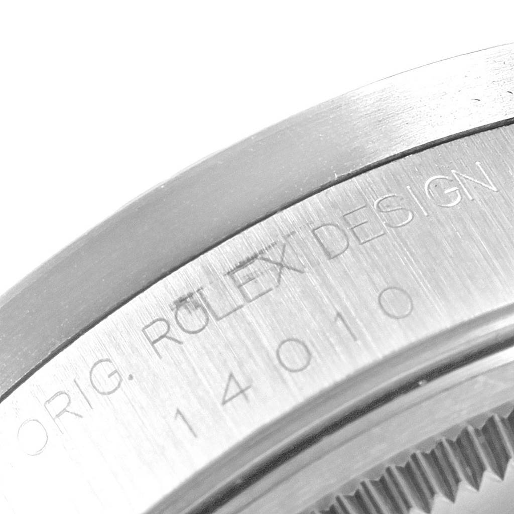 The image shows a close-up of the edge and engraved text on the casing of a Rolex Air-King 14010 Men's Stainless Steel Silver Dial 14010 Men's Stainless Steel Silver Dial watch.