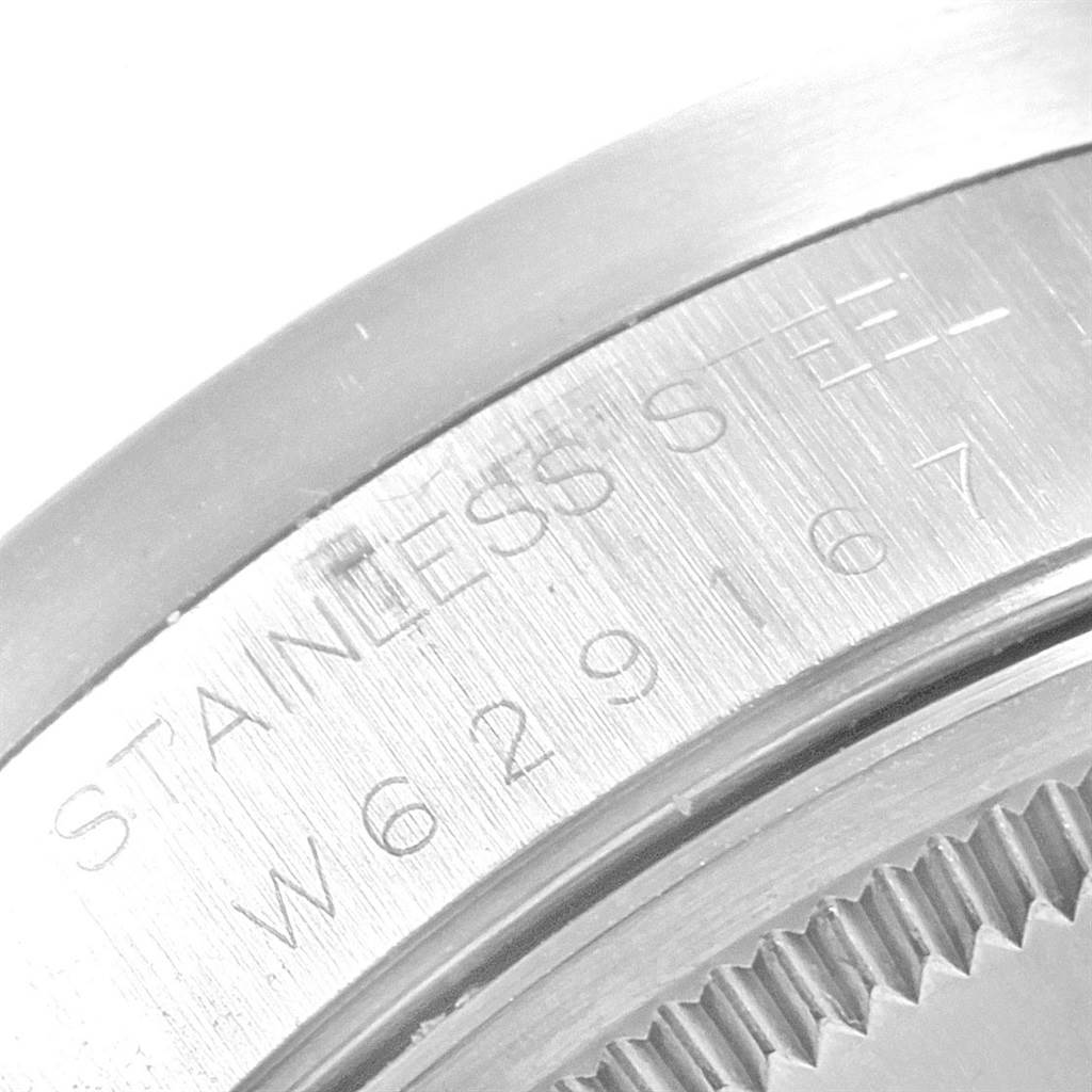 The image shows a close-up of the back case edge of a Rolex Air-King 14010 Men's Stainless Steel Silver Dial 14010 Men's Stainless Steel Silver Dial watch, featuring the serial number and "STAINLESS STEEL" inscription.
