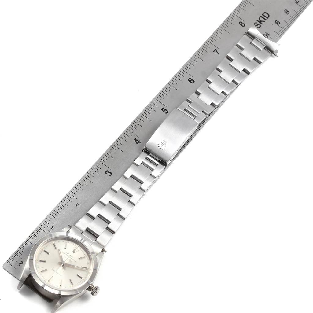 The image shows a top-down view of a Rolex Air-King 14010 Men's Stainless Steel Silver Dial 14010 Men's Stainless Steel Silver Dial watch, displaying the face, bracelet, and clasp beside a ruler.
