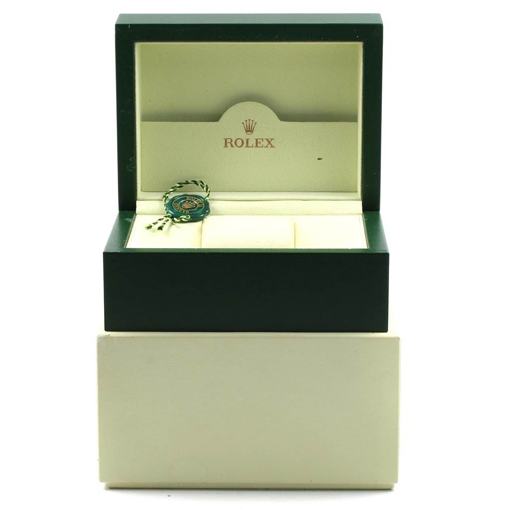 The image shows an open Rolex Air-King 114200 Men's Stainless Steel White Dial 114200 Men's Stainless Steel White Dial watch box with a green and white tag inside.
