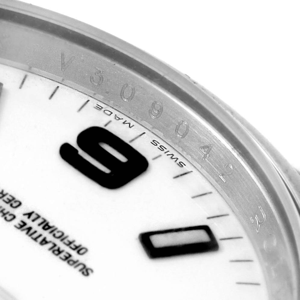 The image shows a close-up angle of the Rolex Air-King 114200 Men's Stainless Steel White Dial 114200 Men's Stainless Steel White Dial watch's dial and inner bezel, highlighting the "SWISS MADE" inscription and part of the serial number.