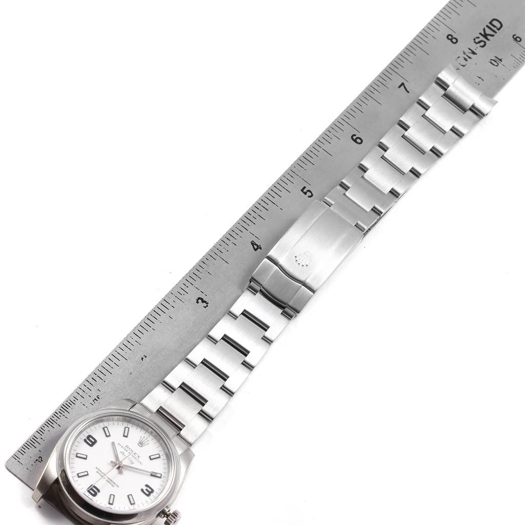 The image shows a Rolex Air-King 114200 Men's Stainless Steel White Dial 114200 Men's Stainless Steel White Dial watch laid flat with its stainless steel bracelet extended and measured against a ruler.