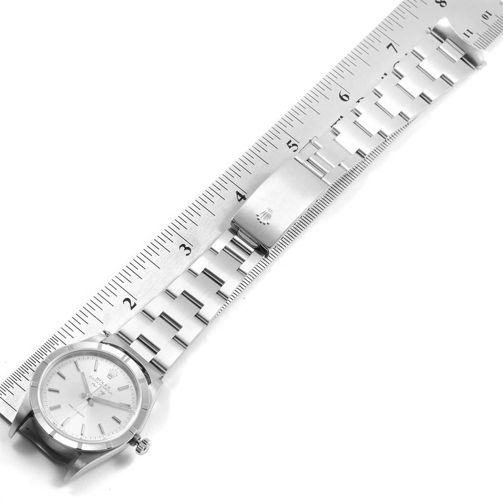 The Rolex Air-King 14010 Men's Stainless Steel Silver Dial 14010 Men's Stainless Steel Silver Dial watch is shown from a top-down angle with its strap measured against a ruler.