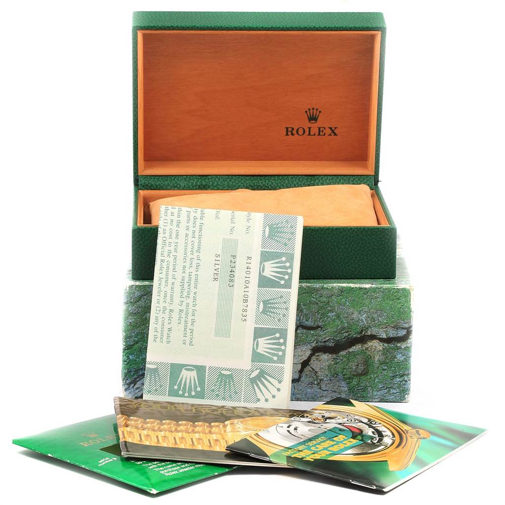 The image shows the interior of a Rolex Air-King 14010 Men's Stainless Steel Silver Dial 14010 Men's Stainless Steel Silver Dial watch box with accompanying booklets and a warranty card.