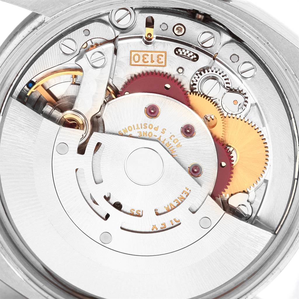 The image shows the internal mechanical movement of the Rolex Air-King 114234 Men's Stainless Steel Blue Dial 114234 Men's Stainless Steel Blue Dial watch, highlighting its gears and intricate components from a top-down angle.