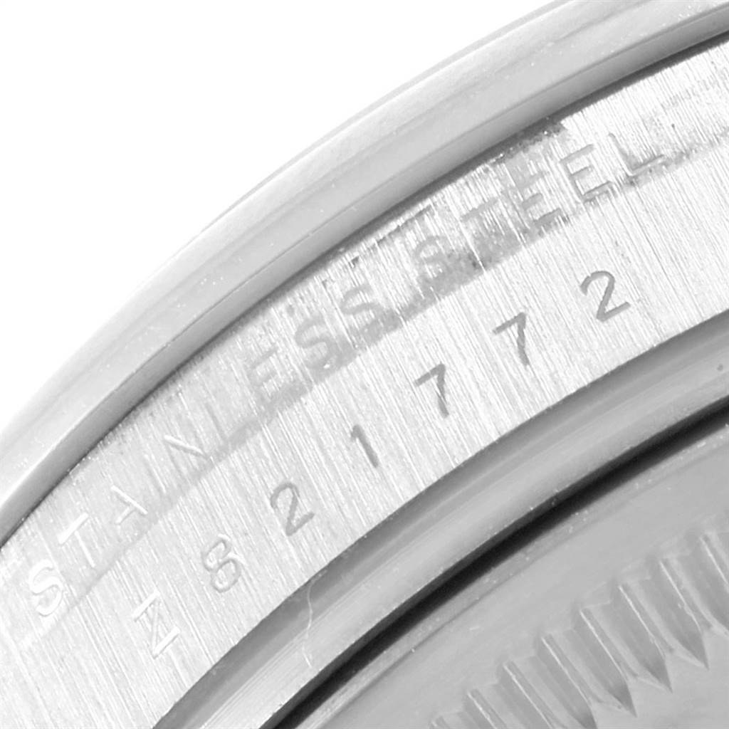 This close-up image shows the stainless steel case side of the Rolex Air-King 114200 Stainless Steel Silver Dial 114200 Stainless Steel Silver Dial watch, featuring engraved details and the serial number.