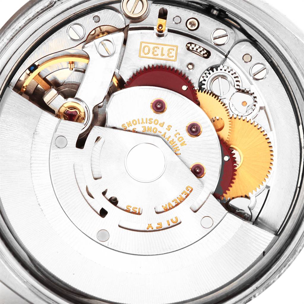 The image shows a close-up of the internal mechanism of a Rolex Air-King 114200 Stainless Steel Silver Dial 114200 Stainless Steel Silver Dial watch, highlighting gears and components.