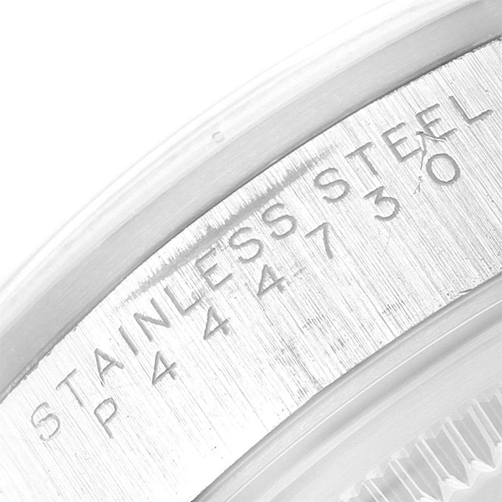 This image shows a close-up of the inner rim of the bezel with "STAINLESS STEEL" and a serial number engraved on a Rolex Air-King 14000 Men's Stainless Steel Black Dial 14000 Men's Stainless Steel Black Dial.