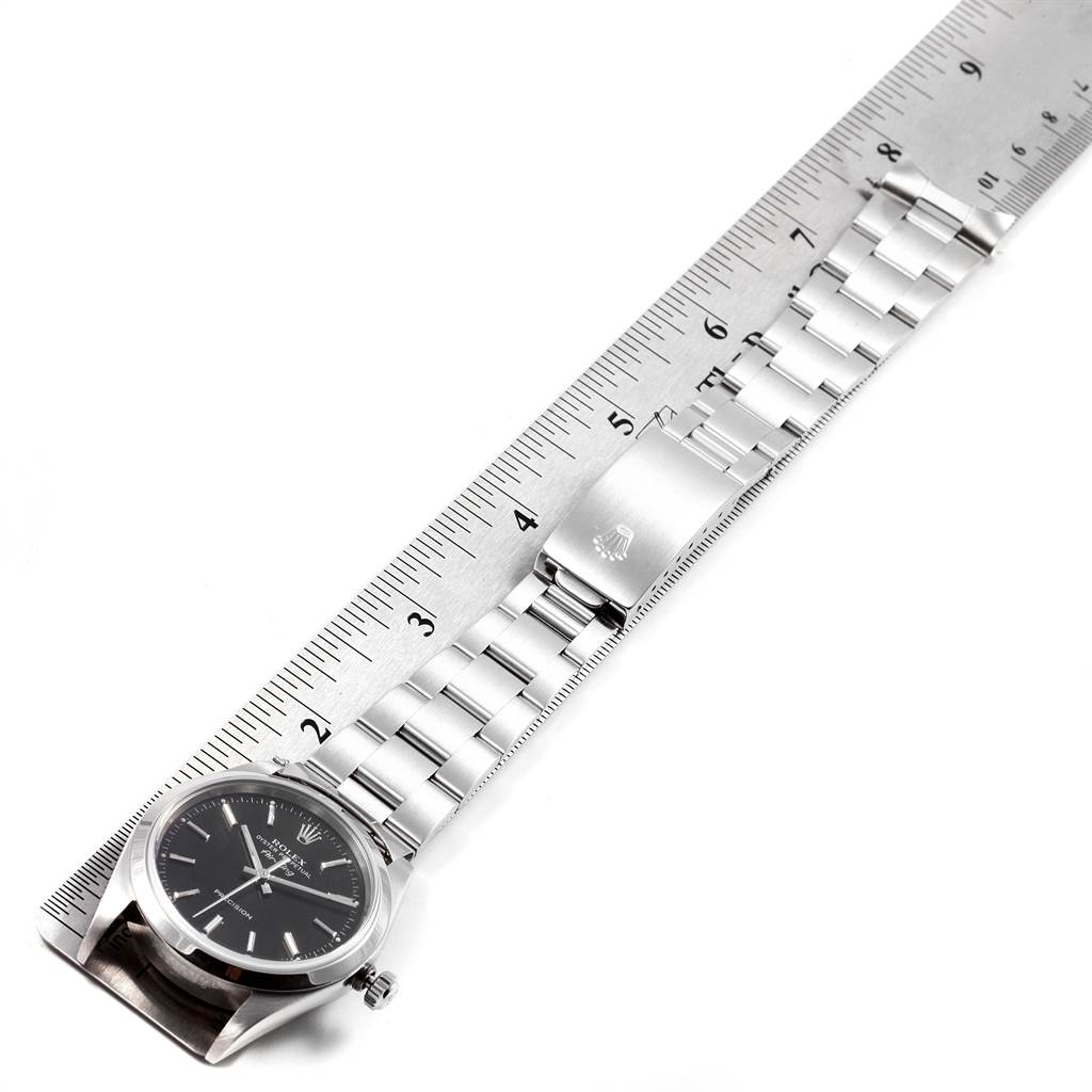 The image shows a Rolex Air-King 14000 Men's Stainless Steel Black Dial 14000 Men's Stainless Steel Black Dial watch laid flat against a ruler, showcasing its bracelet and clasp.