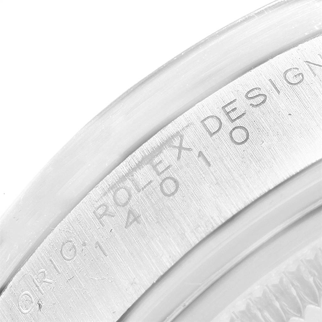 The image shows a close-up view of the edge of the Rolex Air-King 14010 Men's Stainless Steel White Dial 14010 Men's Stainless Steel White Dial watch case, highlighting the engraved serial number and text.