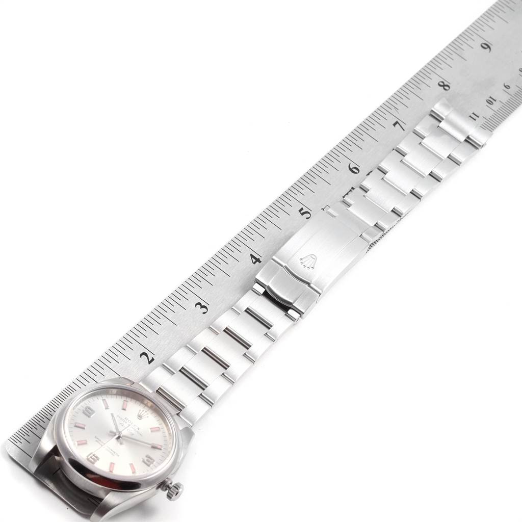 The image shows a Rolex Air-King 114200 Men's Stainless Steel Silver Dial 114200 Men's Stainless Steel Silver Dial watch lying flat with its bracelet fully extended alongside a ruler.