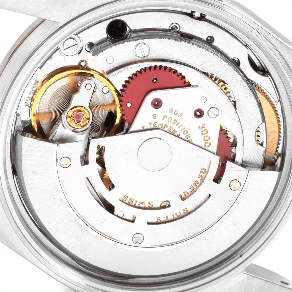 The image shows a close-up of the movement parts inside a Rolex Air-King 14000 Men's Stainless Steel Black Dial 14000 Men's Stainless Steel Black Dial watch, including gears and balance wheel.