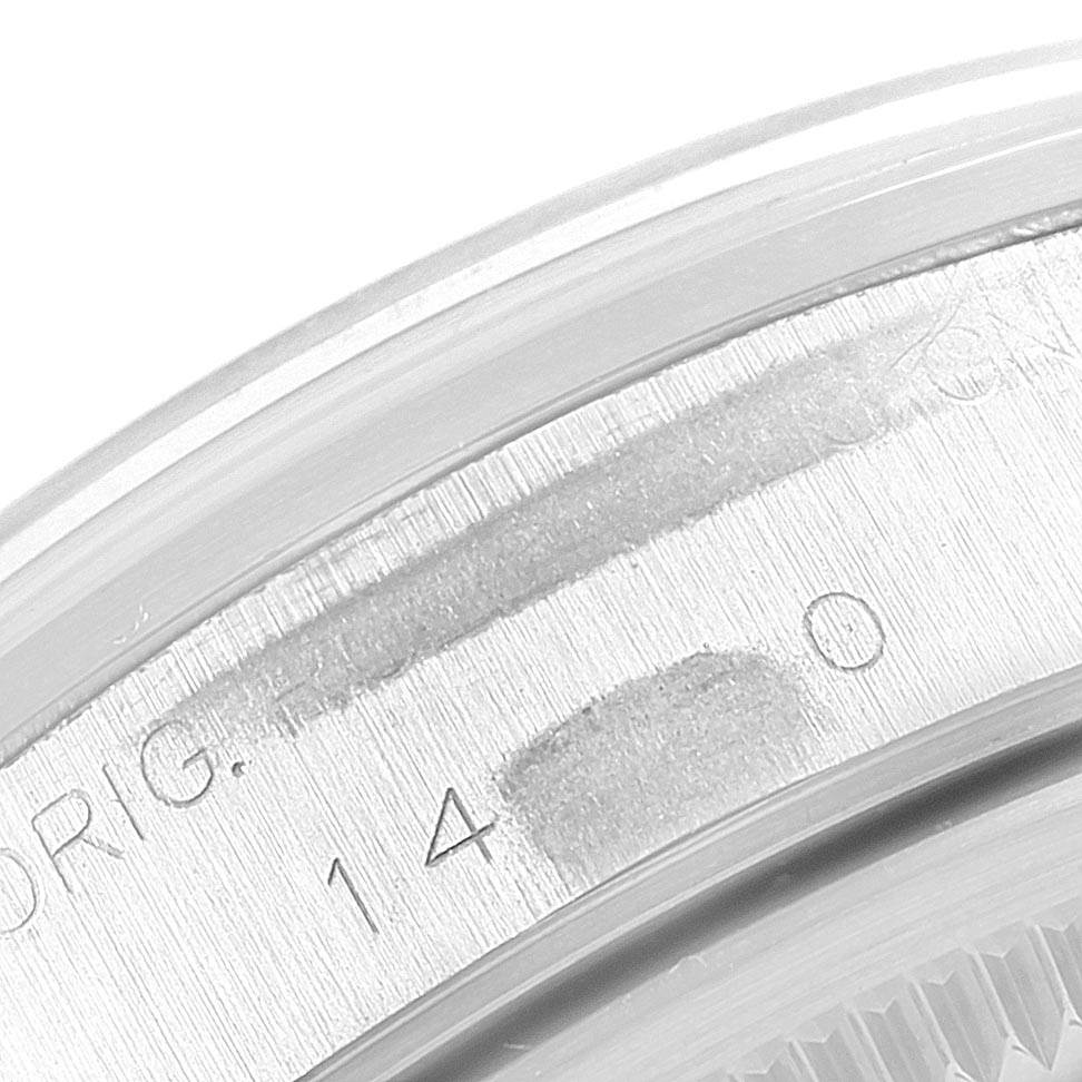 Close-up of the engraving on the case back edge of a Rolex Air-King 14000 Men's Stainless Steel Blue Dial 14000 Men's Stainless Steel Blue Dial watch, showing partial numbers and text.