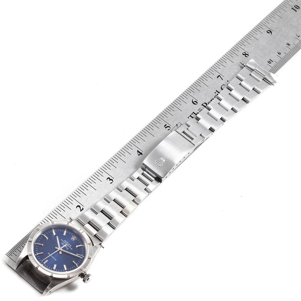 The Rolex Air-King 14010 Men's Stainless Steel Blue Dial 14010 Men's Stainless Steel Blue Dial watch displays its full length, including the dial, bracelet, and clasp, aligned with a measuring ruler.
