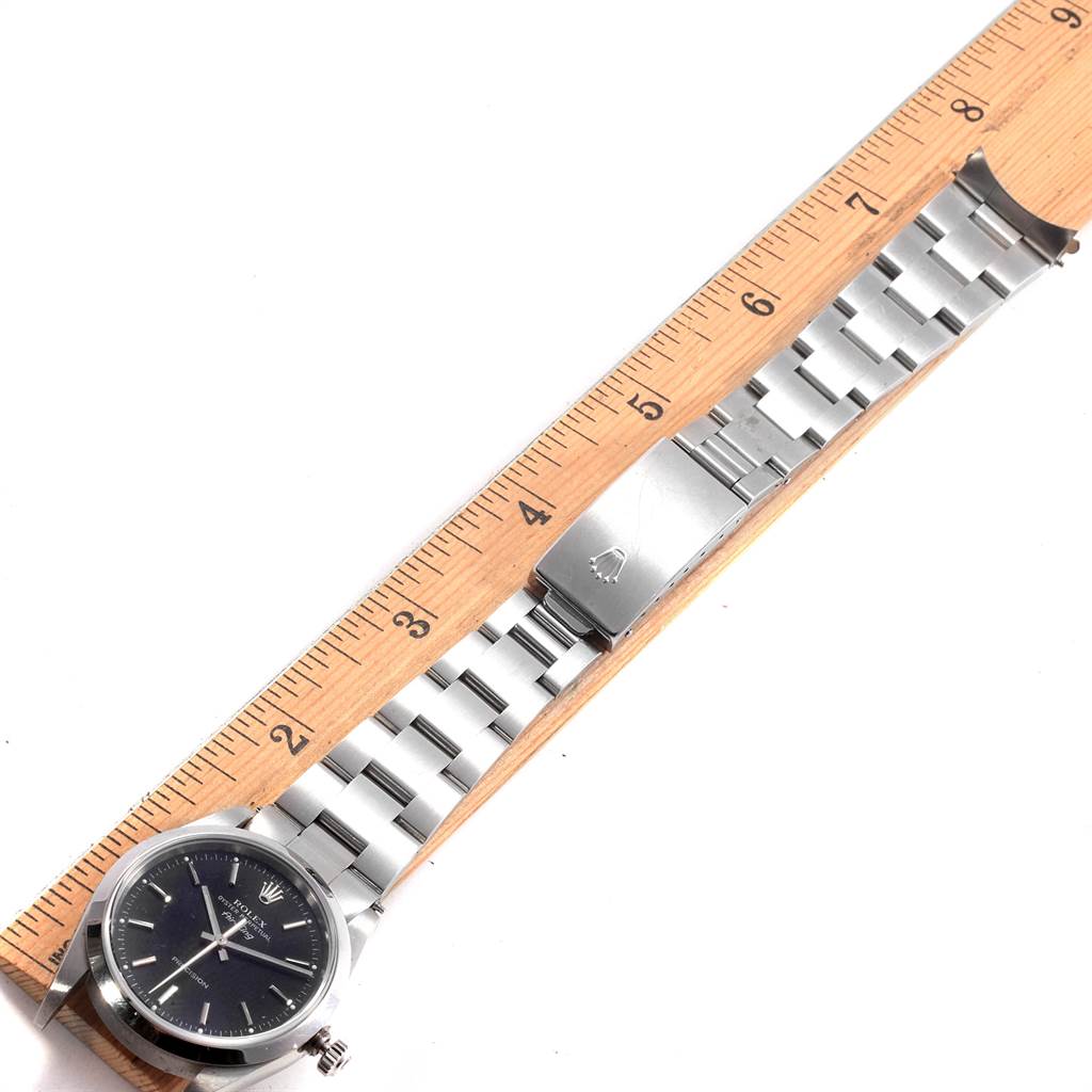 The image shows a Rolex Air-King 14000 Men's Stainless Steel Black Dial 14000 Men's Stainless Steel Black Dial watch laid flat along a ruler, displaying the watch face, stainless steel band, and clasp.