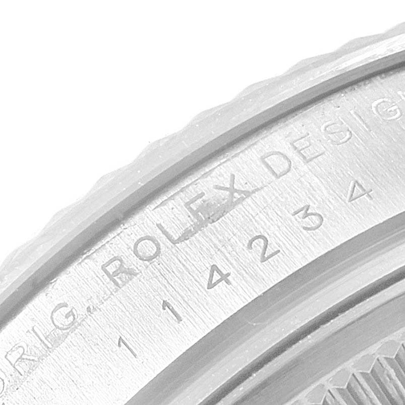 This close-up image shows a portion of the Rolex Air-King 114234 Men's Stainless Steel White Dial 114234 Men's Stainless Steel White Dial watch's bezel with engraved text and numbers.