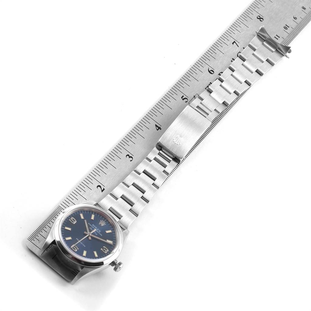 The image shows a Rolex Air-King 14000 Men's Stainless Steel Blue Dial 14000 Men's Stainless Steel Blue Dial watch laid flat next to a ruler, showcasing the face, bracelet, and clasp from a top-down angle.