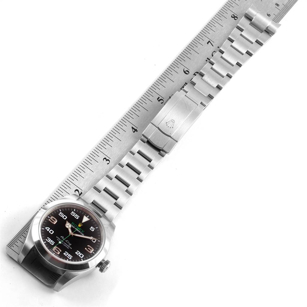 The image shows a top-down view of a Rolex Air-King 116900 Men's Stainless Steel Black Dial 116900 Men's Stainless Steel Black Dial watch with its bracelet, placed next to a ruler for scale.