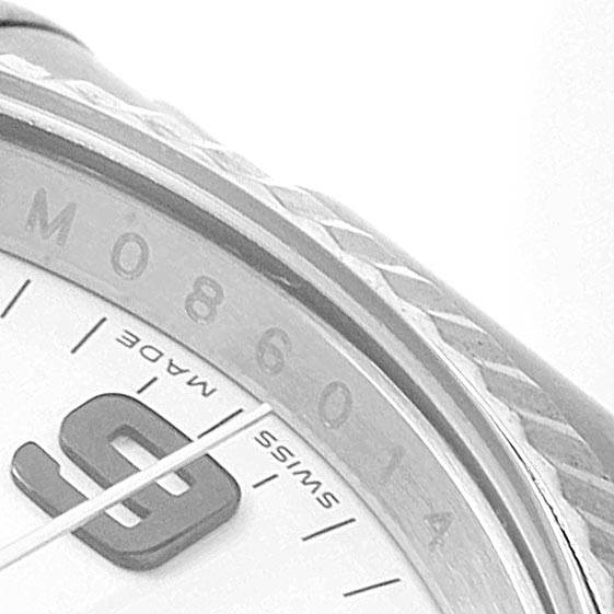 This close-up image of the Rolex Air-King 114234 Men's Stainless Steel White Dial 114234 Men's Stainless Steel White Dial watch shows part of the bezel, the dial with numbers, and a portion of the "Swiss Made" text.