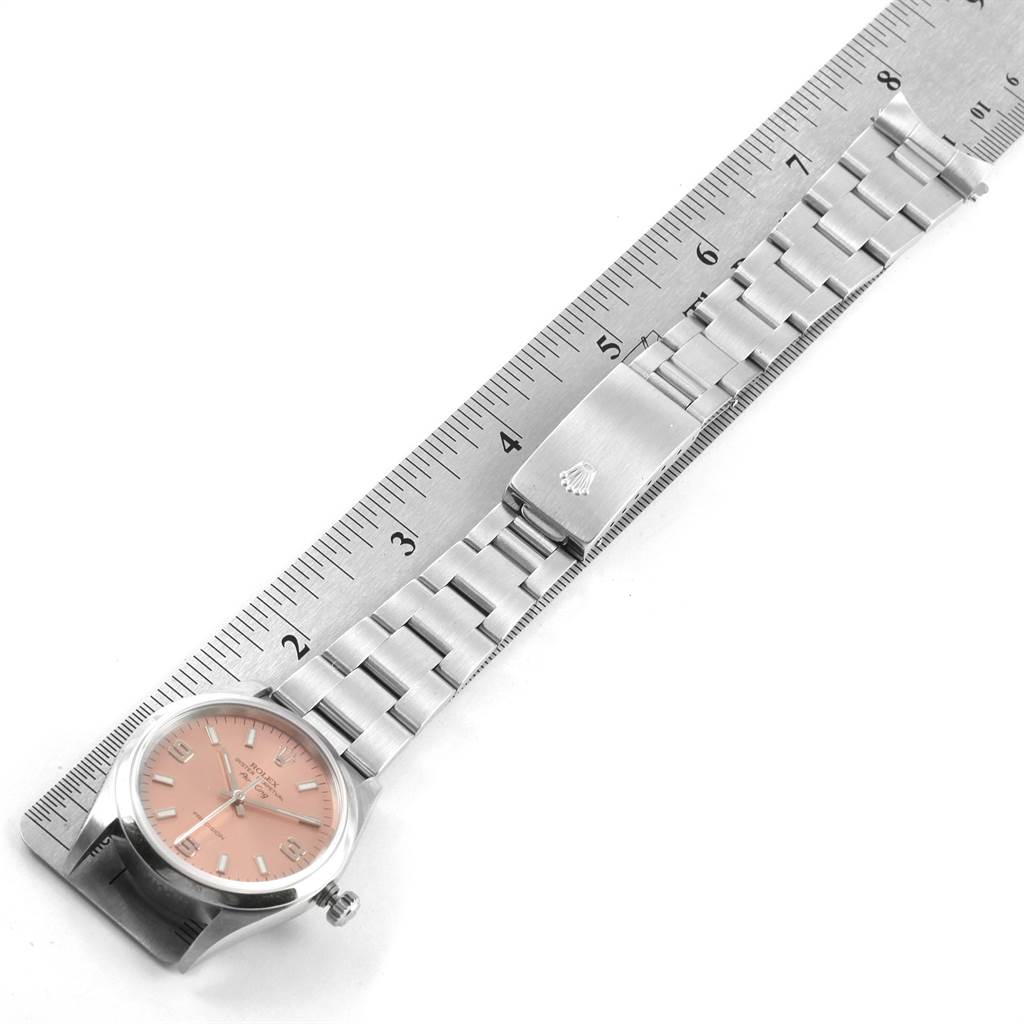 The image shows a flat-lay view of a Rolex Air-King 14000 Men's Stainless Steel Pink Dial 14000 Men's Stainless Steel Pink Dial watch, including its dial, bracelet, and clasp next to a ruler for size reference.