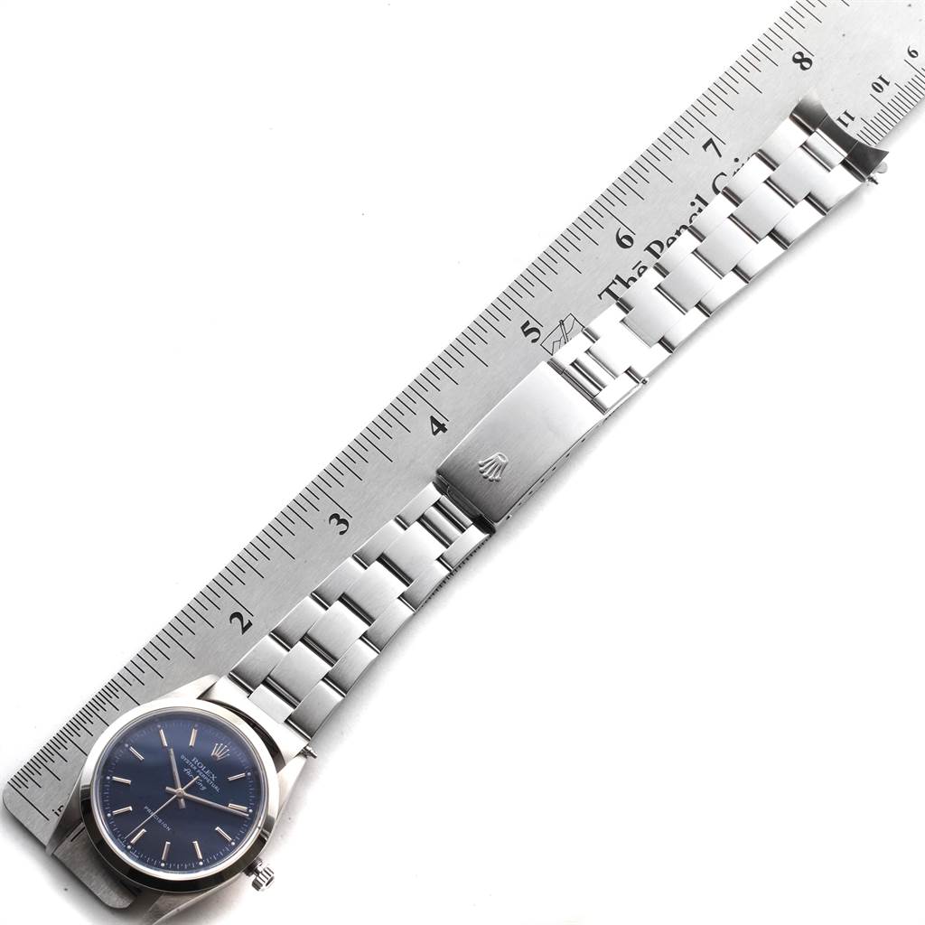 The image shows a top-down view of a Rolex Air-King 14000 Men's Stainless Steel Blue Dial 14000 Men's Stainless Steel Blue Dial watch with a stainless steel bracelet alongside a ruler for scale.