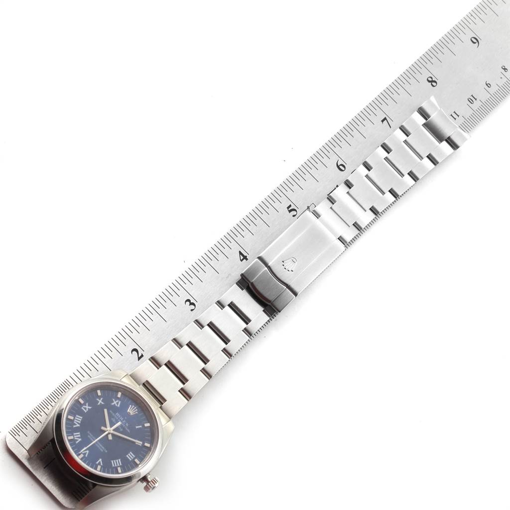 The image shows a Rolex Air-King 114200 Men's Stainless Steel Blue Dial 114200 Men's Stainless Steel Blue Dial watch measured alongside a metal ruler, highlighting the watch's face and bracelet.