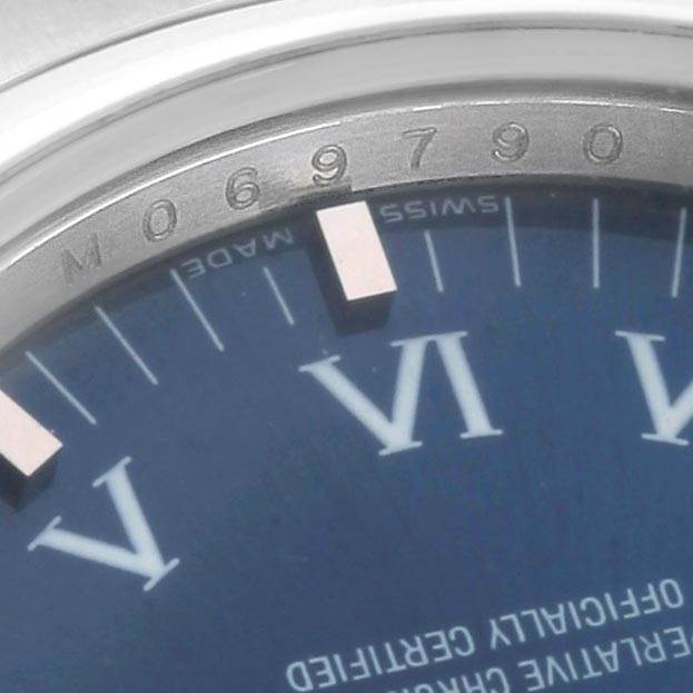 This image shows a close-up of the dial and serial number on the bezel of a Rolex Air-King 114200 Men's Stainless Steel Blue Dial 114200 Men's Stainless Steel Blue Dial watch.