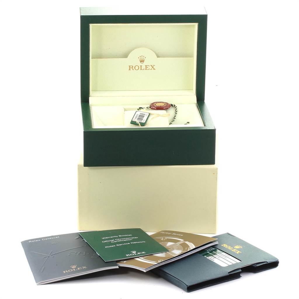 The Rolex Air-King 114200 Men's Stainless Steel Blue Dial 114200 Men's Stainless Steel Blue Dial watch is shown from a top angle inside its open box, with accompanying booklets and accessories displayed.