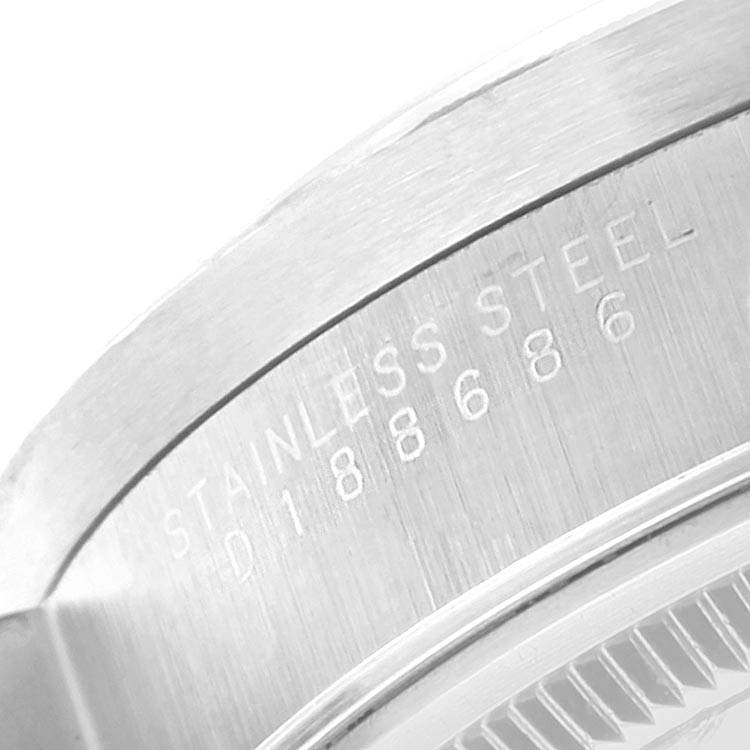 Close-up of the casing of the Rolex Air-King 14010 Men's Stainless Steel Silver Dial 14010 Men's Stainless Steel Silver Dial watch, showing the "Stainless Steel" engraving and partial serial number.