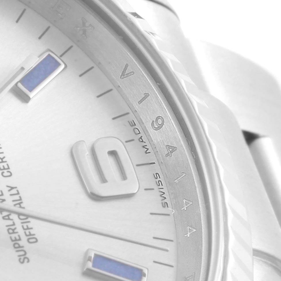 The image shows a close-up of the Rolex Air-King 114234 Men's Stainless Steel Silver Dial 114234 Men's Stainless Steel Silver Dial watch, focusing on its bezel, part of the dial, and numeral markers.