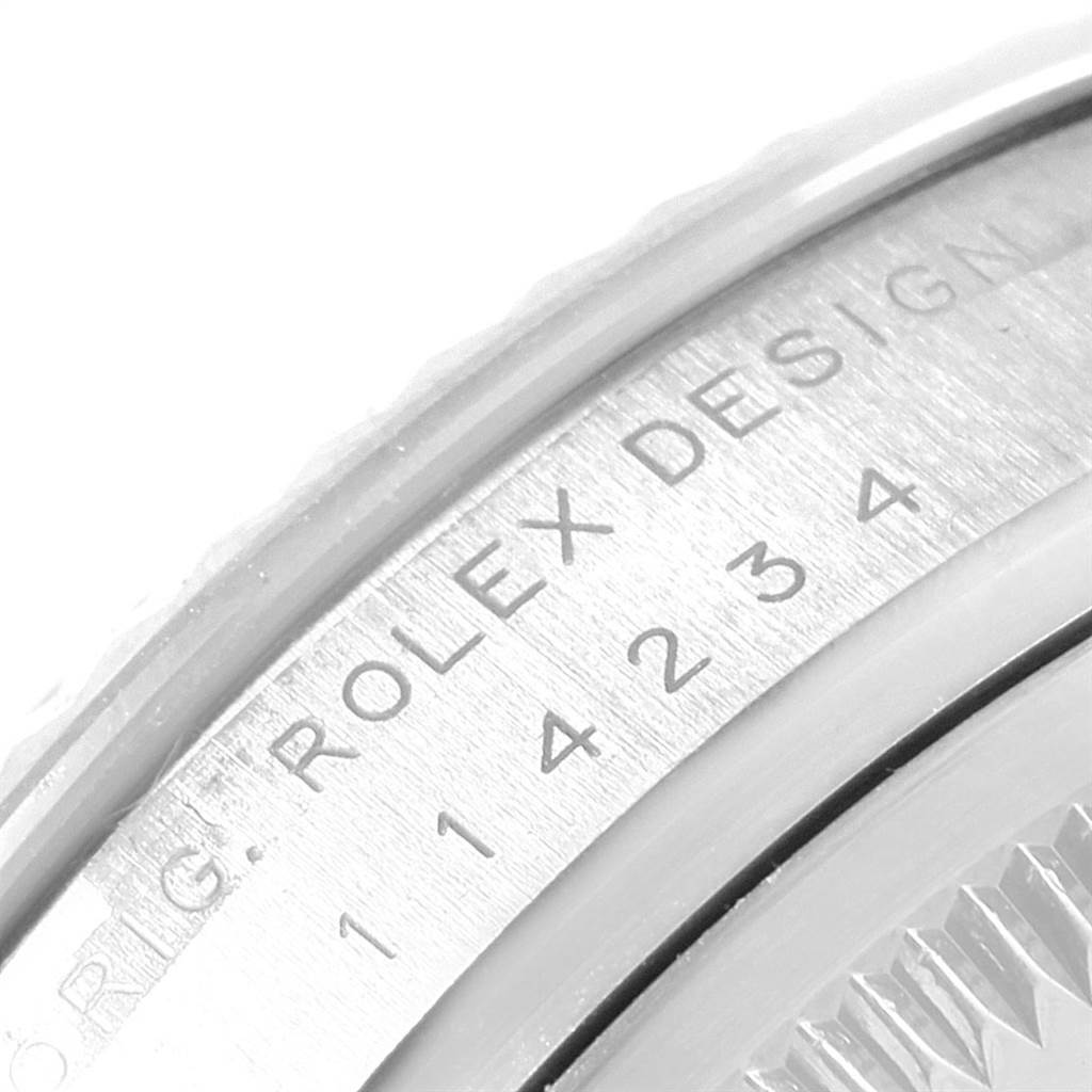 The image shows a close-up of the case back engraving of a Rolex Air-King 114234 Men's Stainless Steel Silver Dial 114234 Men's Stainless Steel Silver Dial watch, highlighting the "ROLEX DESIGN" text and serial numbers.