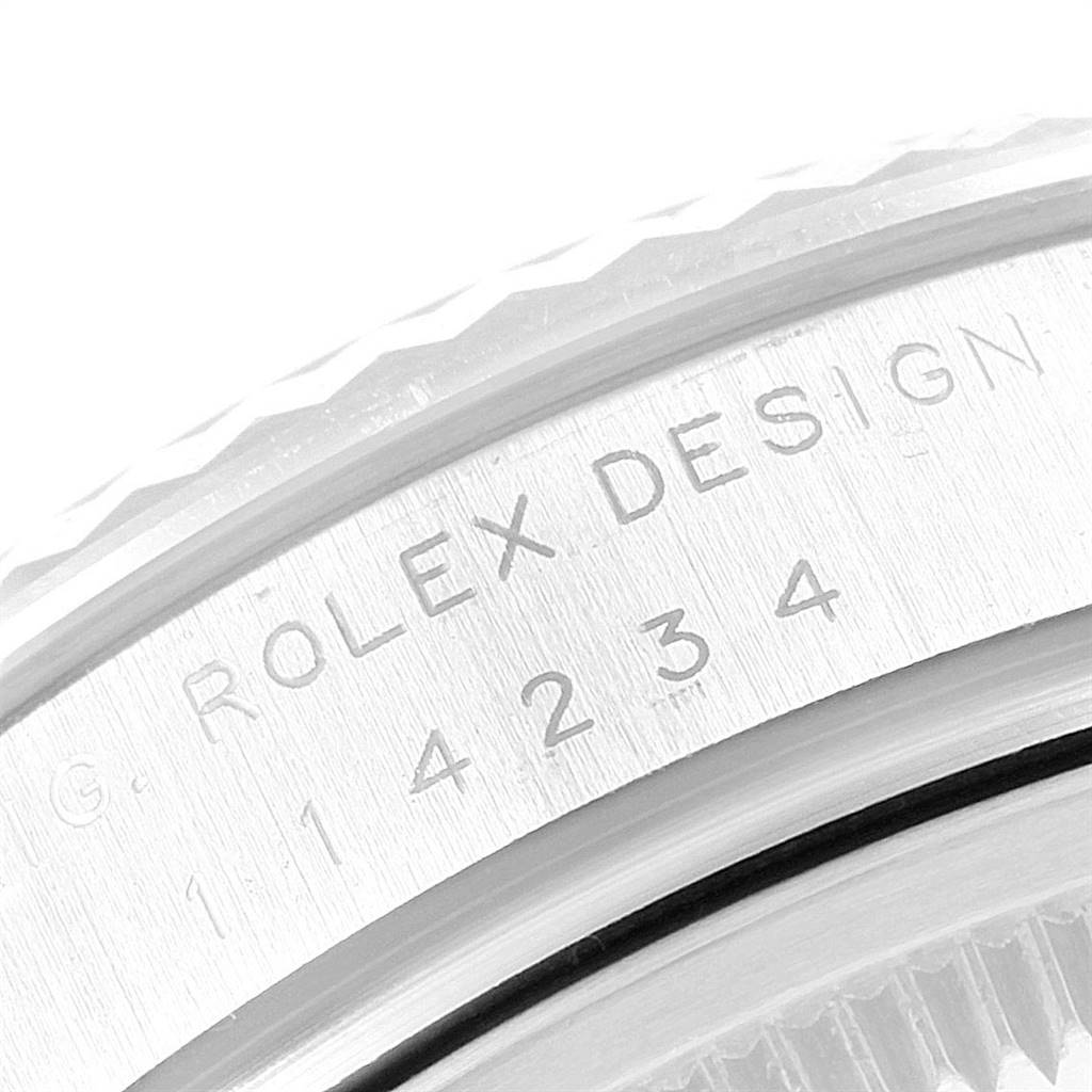 This close-up image shows the engraved serial number and "Rolex Design" on the case of a Rolex Air-King 114234 Men's Stainless Steel Silver Dial 114234 Men's Stainless Steel Silver Dial watch.
