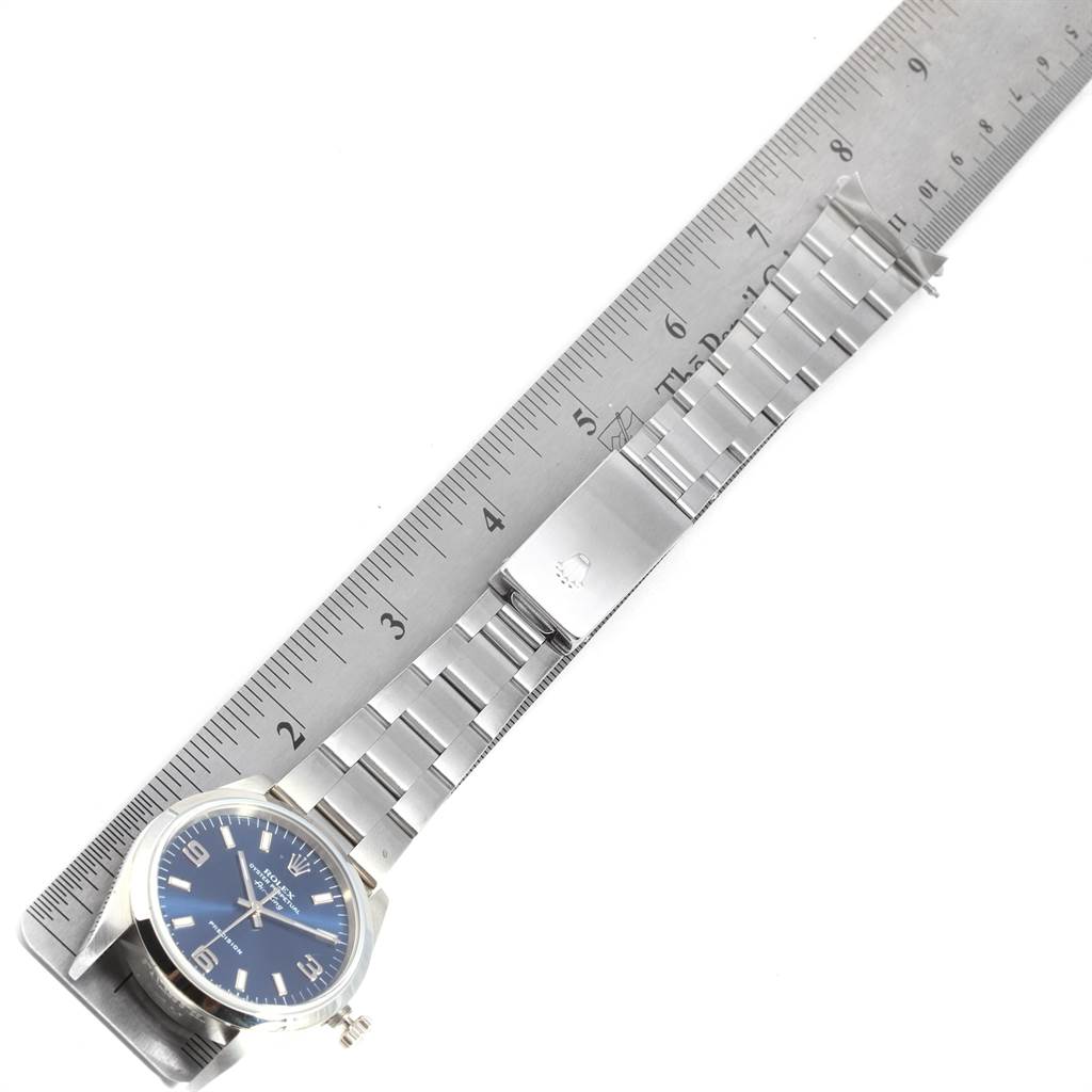 The image shows a Rolex Air-King 14000 Men's Stainless Steel Blue Dial 14000 Men's Stainless Steel Blue Dial watch with a side angle view, showcasing the dial, bracelet, and clasp, against a ruler for measurement.