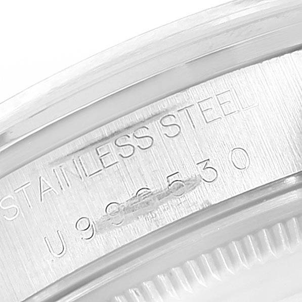 This image shows a close-up of the serial number and "STAINLESS STEEL" engraving on a Rolex Air-King 14000 Men's Stainless Steel Blue Dial 14000 Men's Stainless Steel Blue Dial watch case.