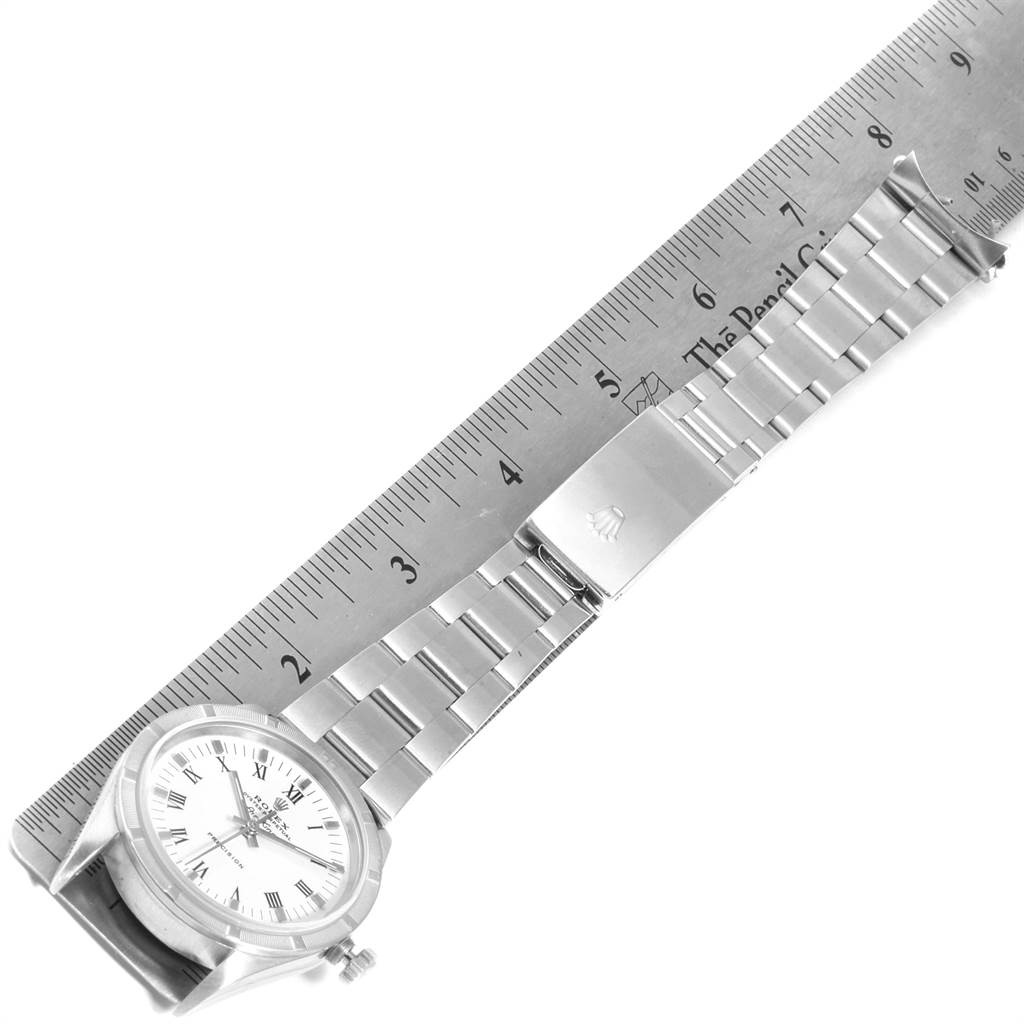 The image shows a side view of the Rolex Air-King 14010 Men's Stainless Steel White Dial 14010 Men's Stainless Steel White Dial watch with its bracelet and clasp extended along a ruler.
