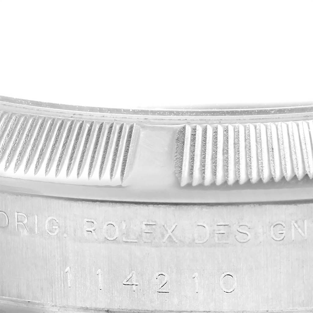 This image shows a close-up of the bezel and engraved design number on a Rolex Air-King 114210 Men's Stainless Steel Blue Dial 114210 Men's Stainless Steel Blue Dial watch.