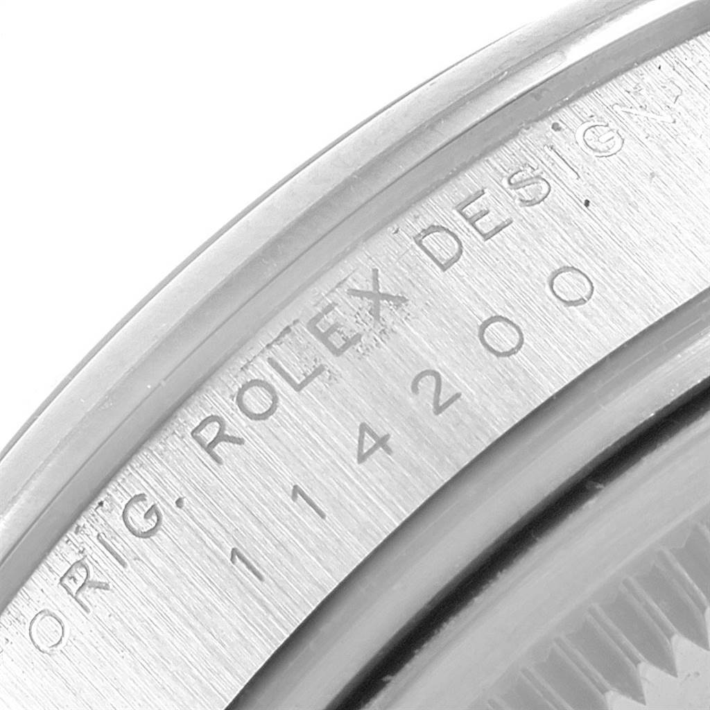 This is a close-up view of the serial number "114200" on the bezel of the Rolex 114200 Stainless Steel Silver Dial 114200 Stainless Steel Silver Dial Air King Silver Dial Pink Baton Markers Unisex Watch.
